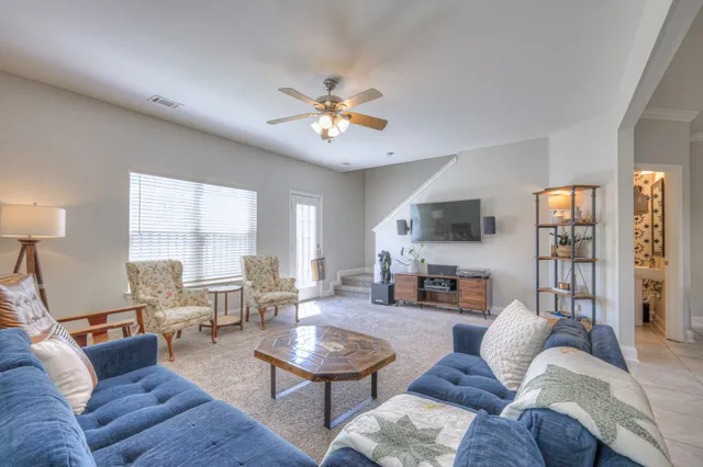 a living room with furniture fireplace and a large window