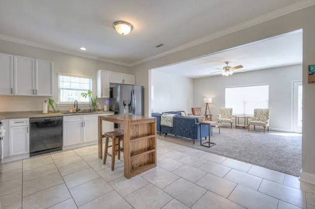 a kitchen with cabinets and chairs