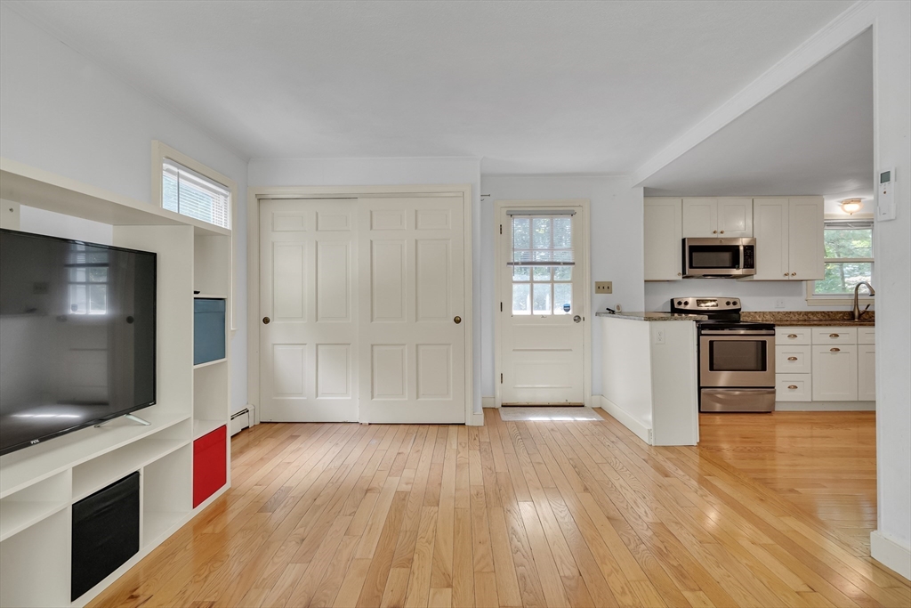 32 Dewey Road Lexington, MA 02420 - Photo 15 of 32 a kitchen with stainless steel appliances wooden floor and view living room