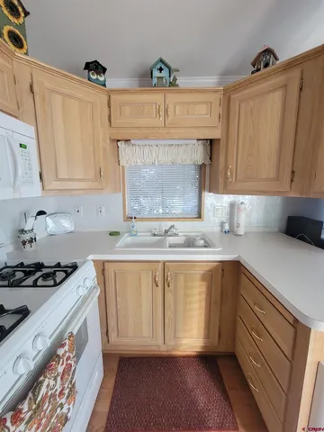 a bedroom with a bed and teddy bear on a bed