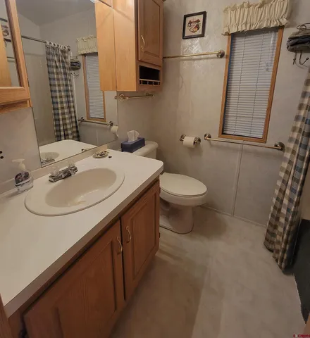 a white toilet sitting next to a bathroom sink