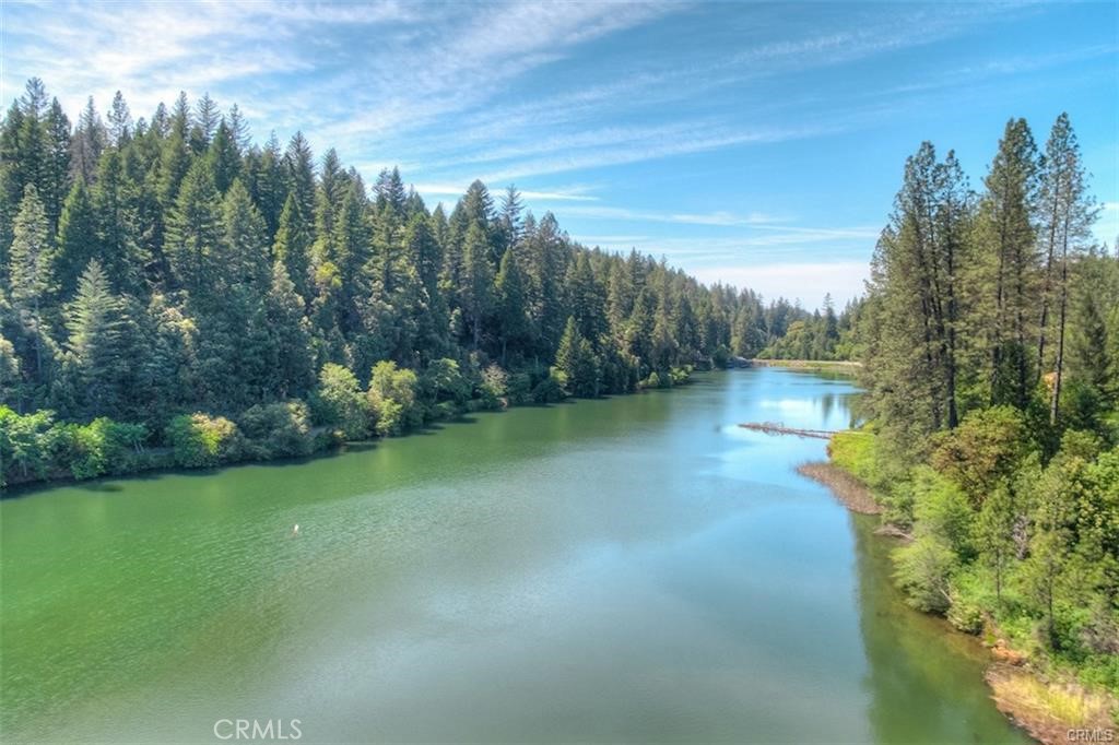0 Pavlik Pines Road Berry Creek, CA 95916 - Photo 16 of 26 a view of a lake with a house in the background