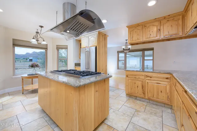 a kitchen with stainless steel appliances granite countertop a stove a refrigerator and a refrigerator