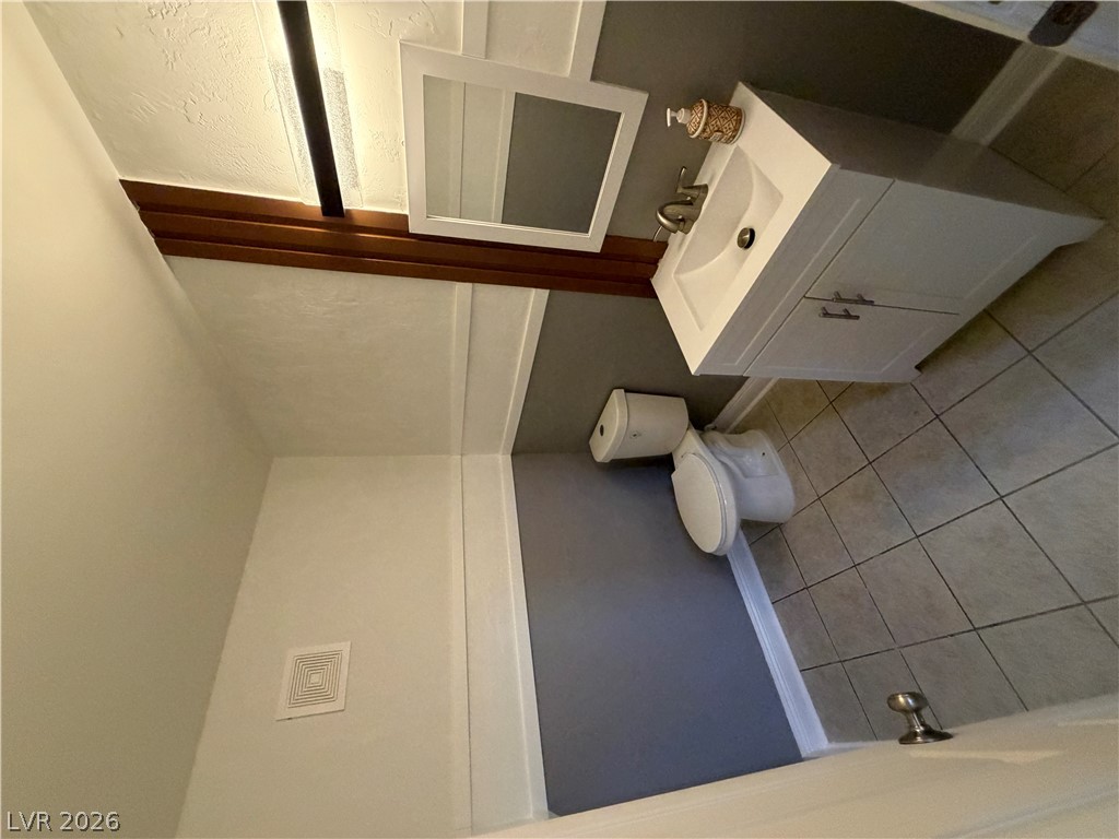 2236 East Desert Inn Road Las Vegas, NV 89169 - Photo 10 of 34 A well-maintained bathroom featuring tiled flooring and a modern vanity.