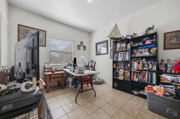 a view of a house with a yard and large tree