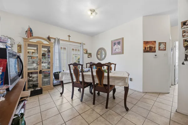 a view of a kitchen with fridge and workspace