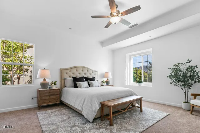 a bedroom with a bed and a lamp