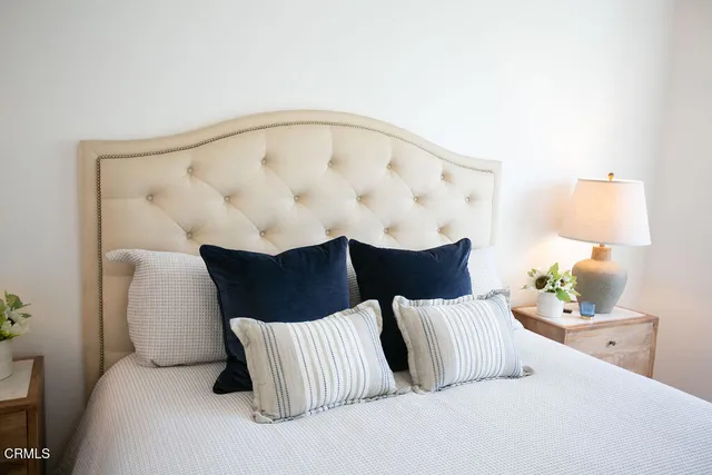 a bathroom with a tub a sink and mirror