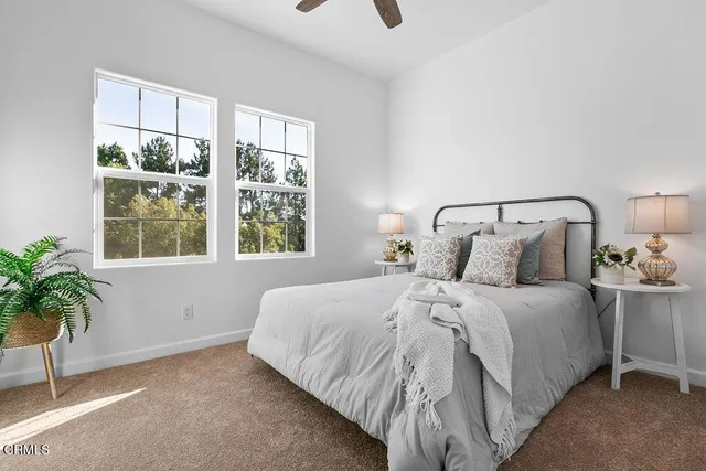 a bed sitting in a bedroom next to a lamp