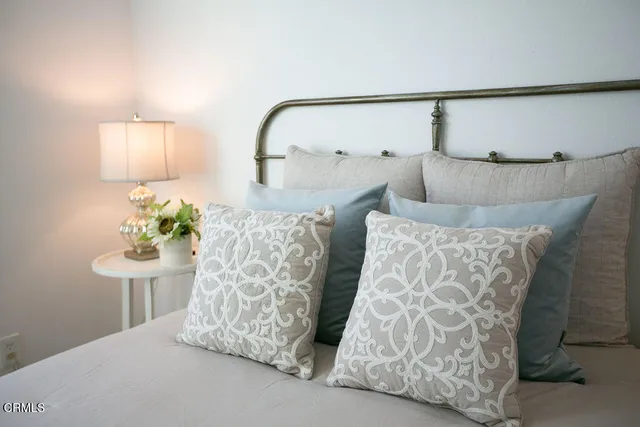 a bedroom with a bed and a lamp