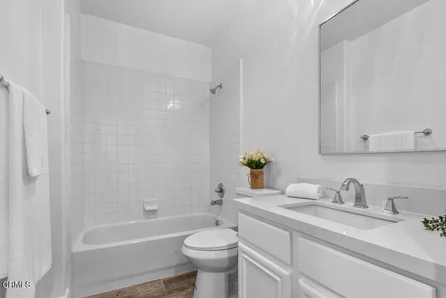 a spacious bedroom with a bed and a window