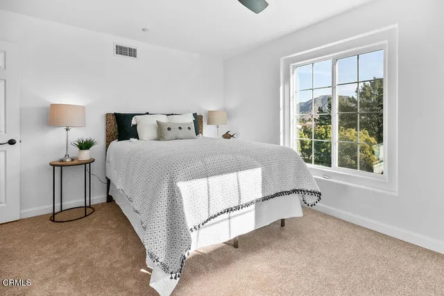 a white bath tub sitting next to a white wall
