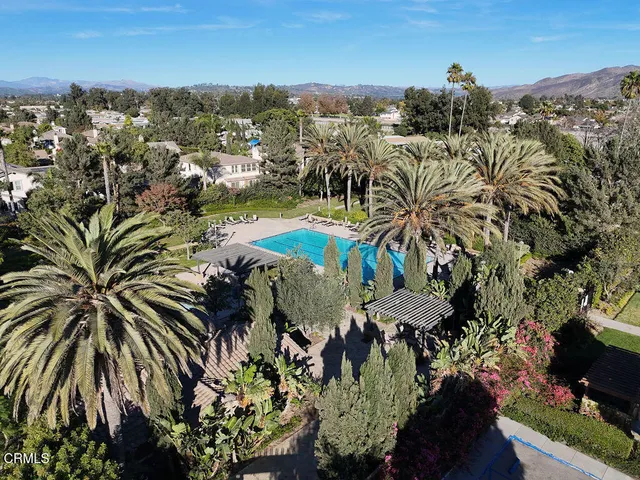 an aerial view of a house with swimming pool and garden