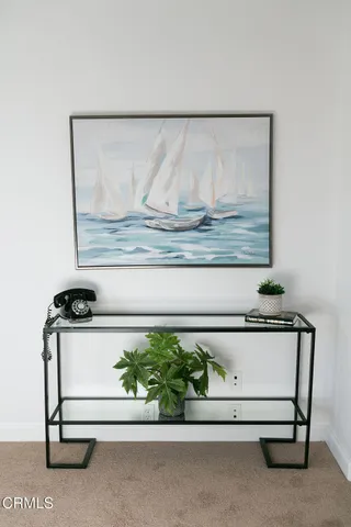 a living room with furniture a fireplace and a potted plant