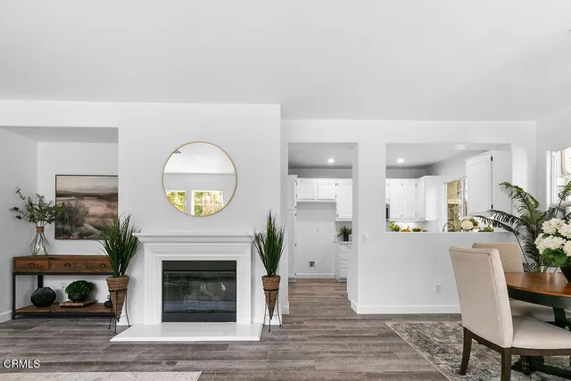 an entryway with fireplace and wooden floor