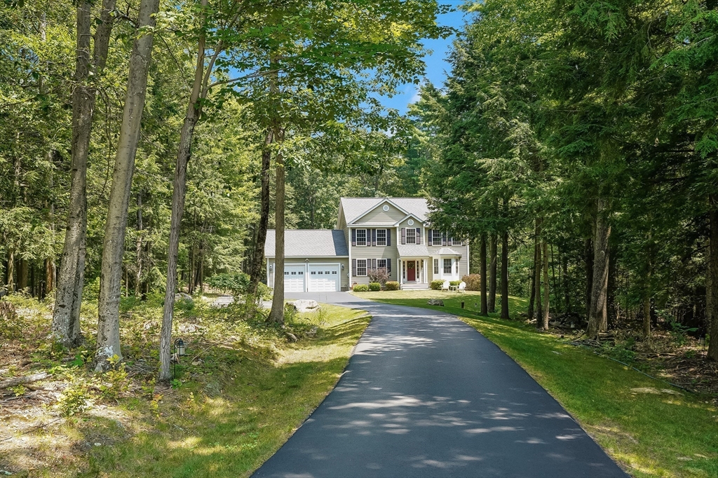 18 Westgate Road Mont Vernon, NH 03057 - Photo 2 of 42 a front view of a house with a yard