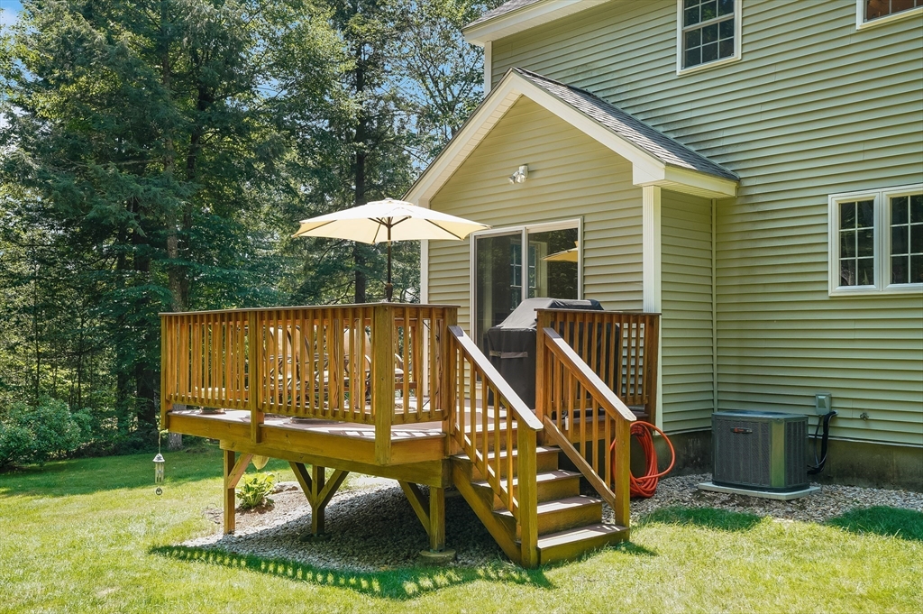 18 Westgate Road Mont Vernon, NH 03057 - Photo 33 of 42 a roof deck with table and chairs under an umbrella