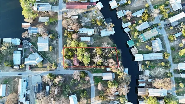 an aerial view of a house with a yard and garden