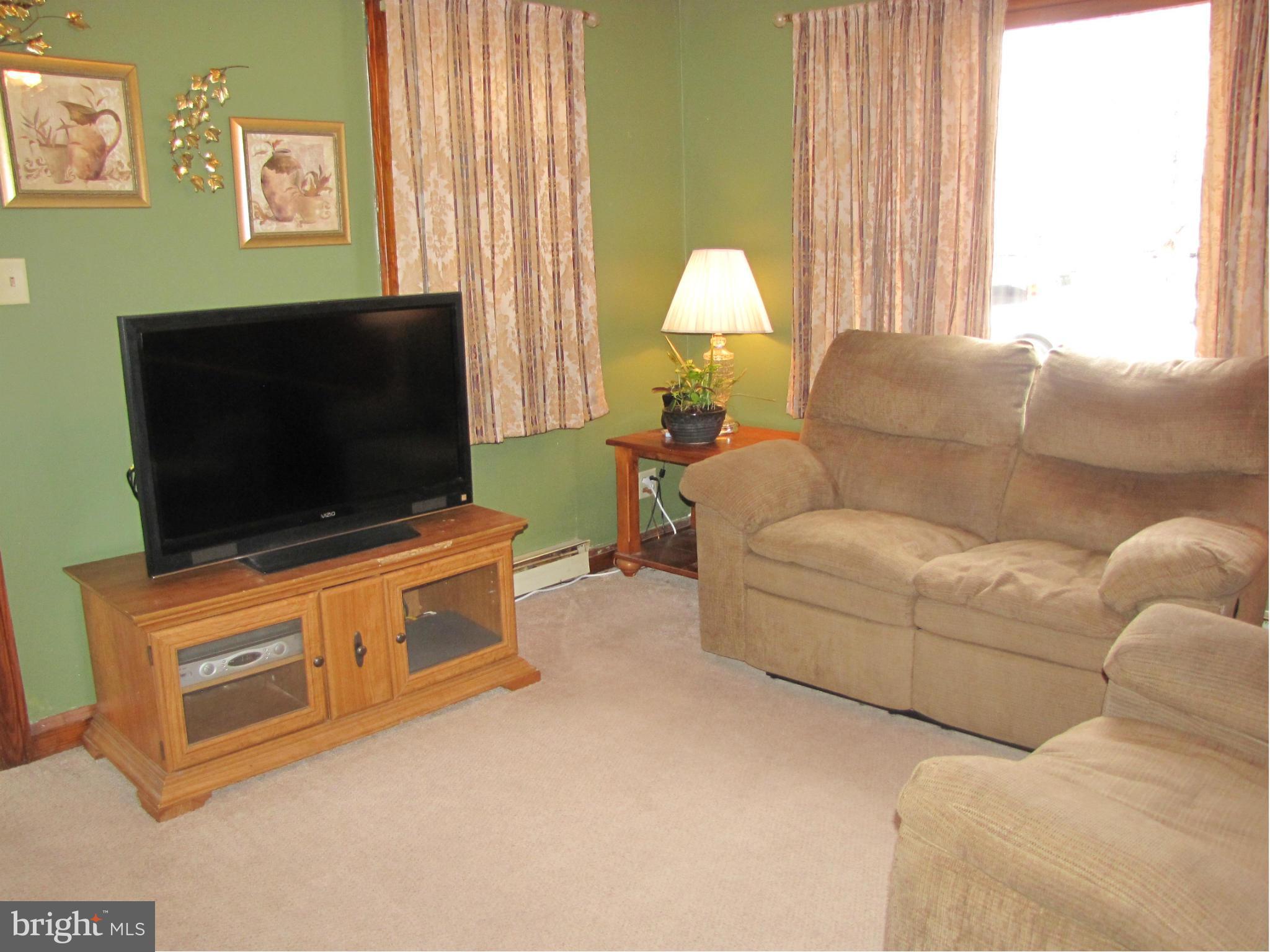27 Brookfield Road Pasadena, MD 21122 - Photo 12 of 20 a living room with furniture and a flat screen tv