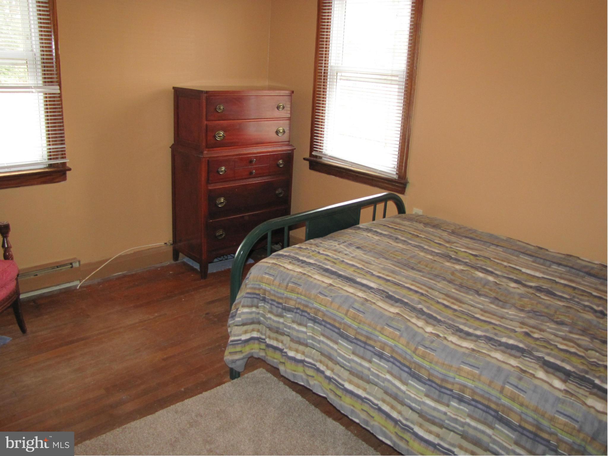 27 Brookfield Road Pasadena, MD 21122 - Photo 14 of 20 a bedroom with a bed and a dresser
