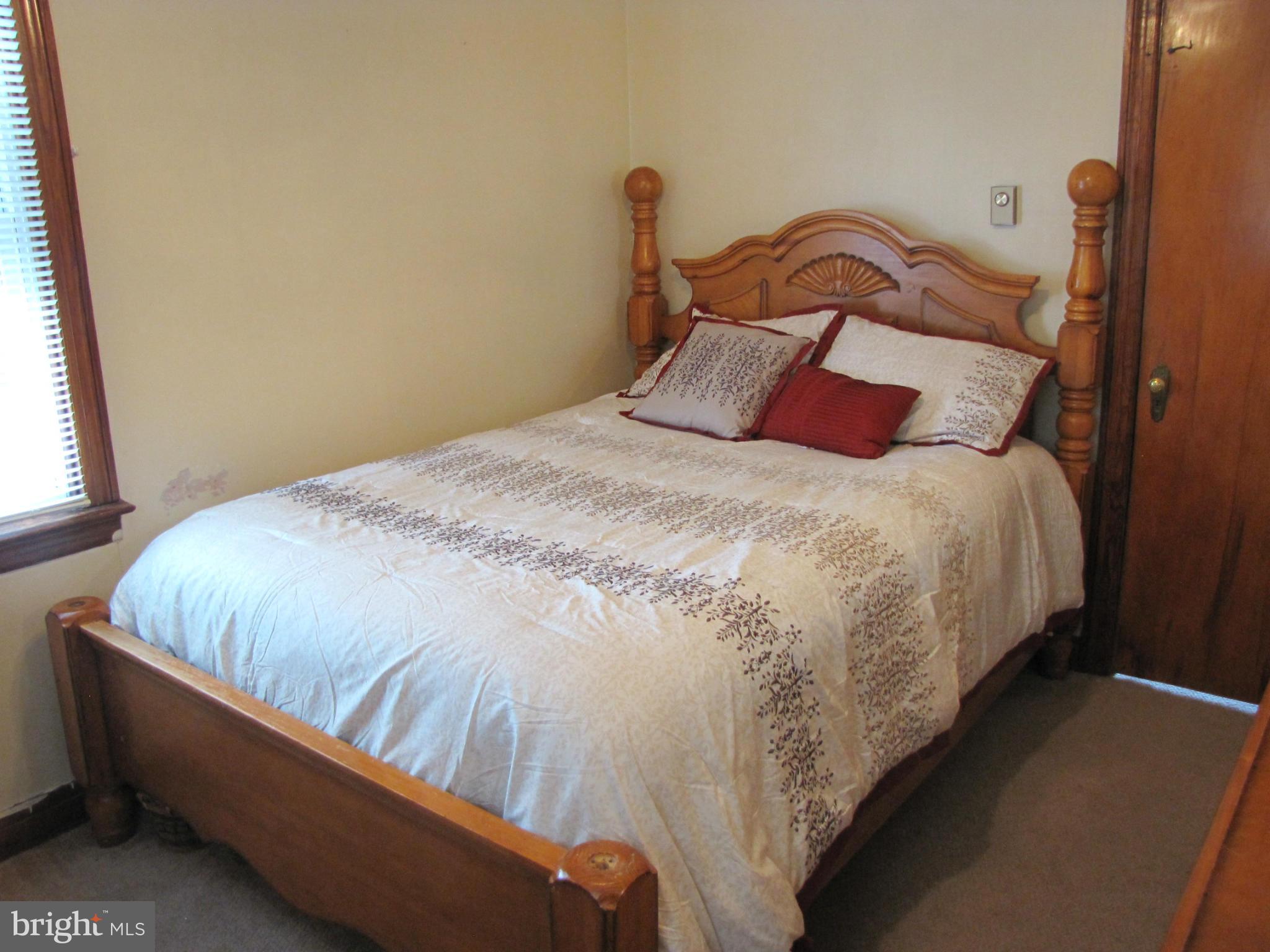27 Brookfield Road Pasadena, MD 21122 - Photo 9 of 20 a bed sitting in a bedroom next to a window