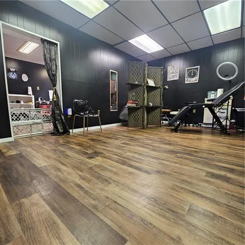 a living room with furniture gym equipment and view of kitchen