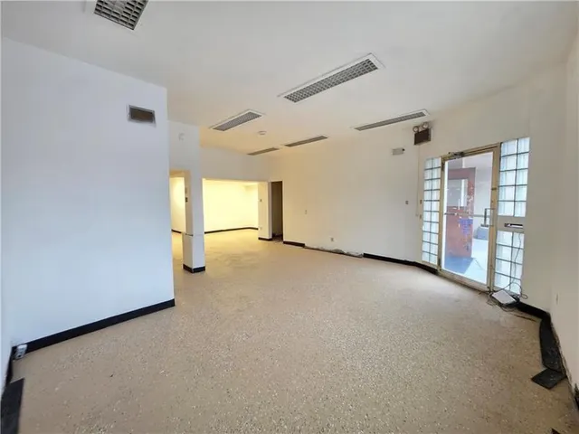 an empty room with a empty space and windows