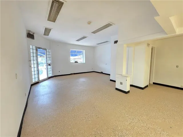 a view of a big room with closet and windows