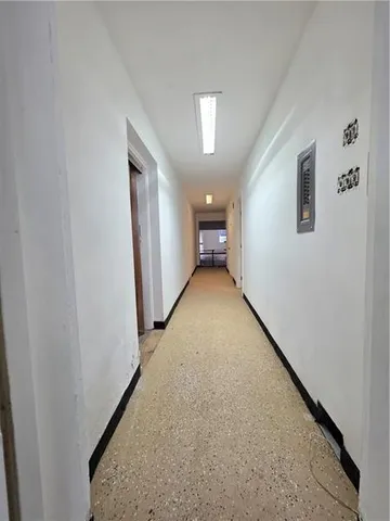 a living room with furniture a table and kitchen view