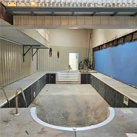 a large kitchen with a table and chairs