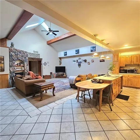 a large kitchen with a table and chairs