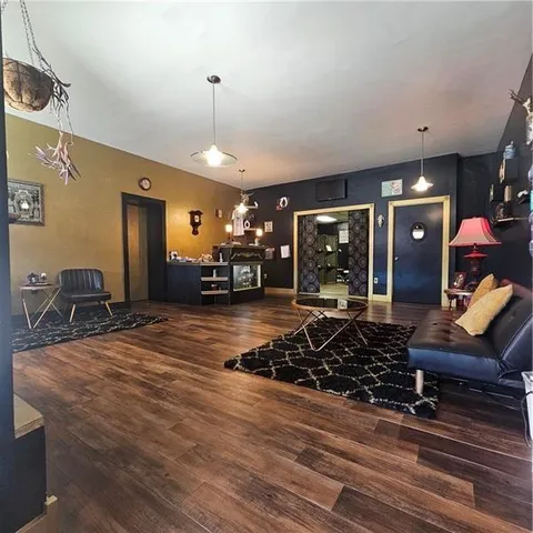 a room with lots of chairs and a chandelier