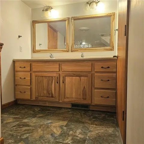 an empty room with a ceiling fan and a window