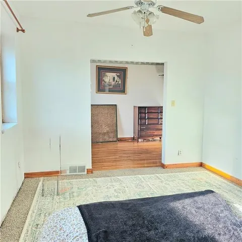 a bathroom with a granite countertop sink and a toilet