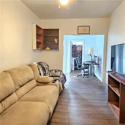 a view of a workspace with furniture and wooden floor