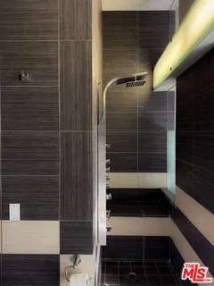 a bathroom with a shower and a sink