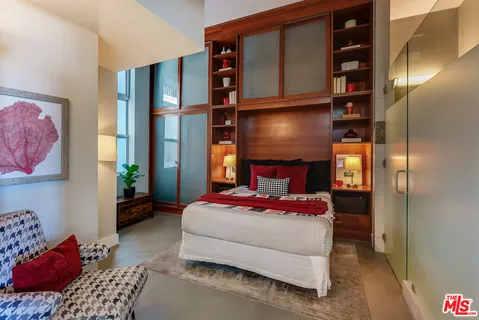 a bedroom with a bed and walk in closet