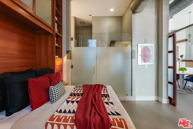 a bedroom with a bed and a book shelf