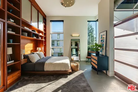 a bedroom with bed and flowerpot