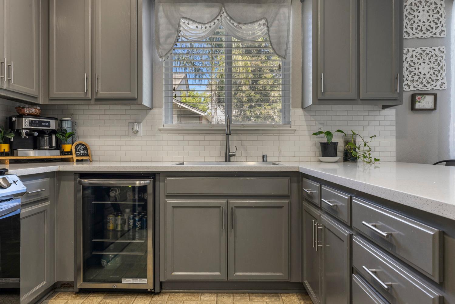 3145 Sweet Pea Avenue Merced, CA 95341 - Photo 12 of 25 a kitchen with stainless steel appliances granite countertop a sink stove and cabinets