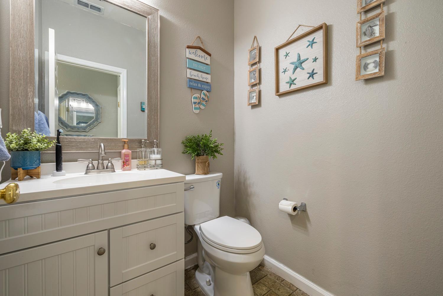 3145 Sweet Pea Avenue Merced, CA 95341 - Photo 13 of 25 a bathroom with a sink mirror vanity and toilet