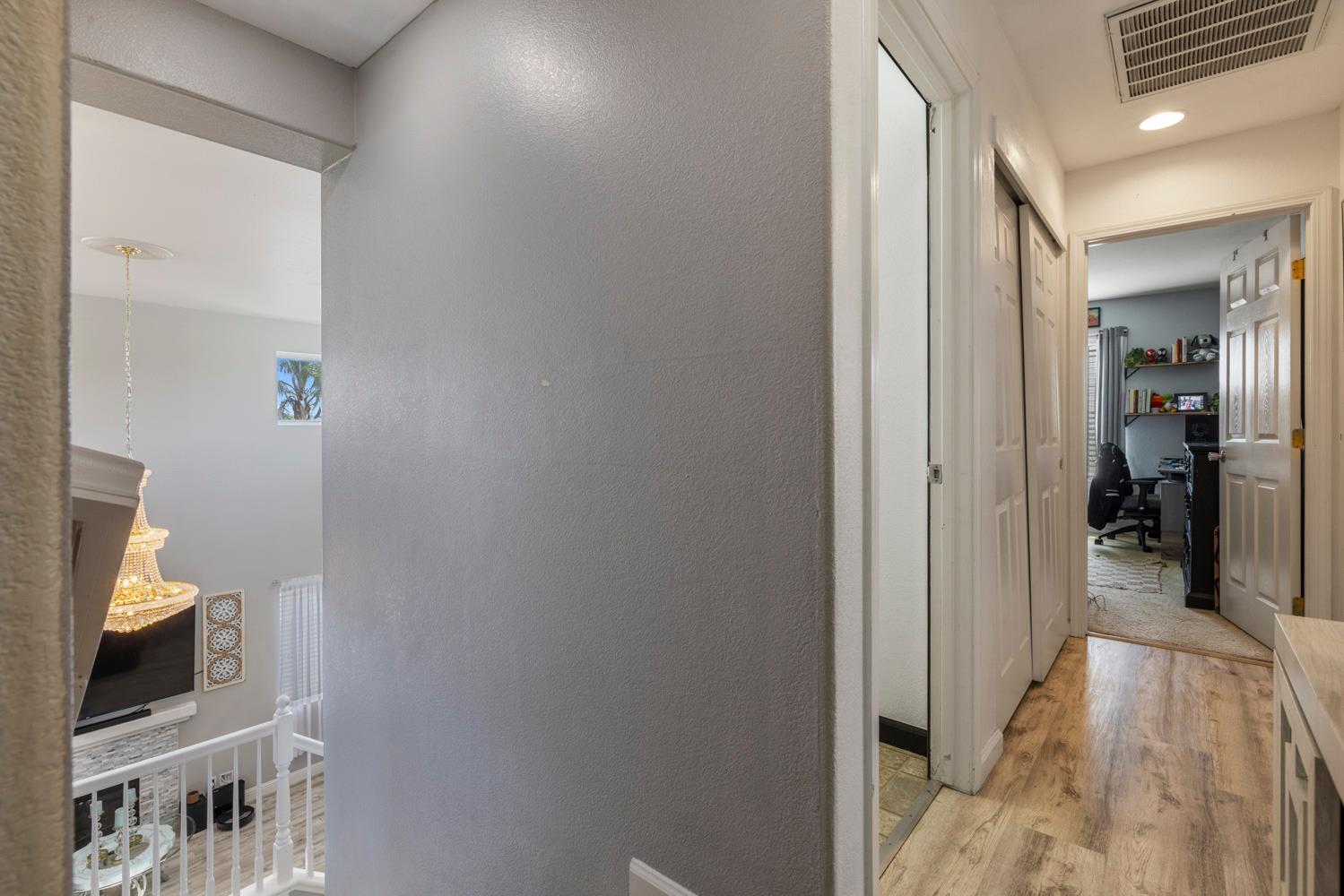 3145 Sweet Pea Avenue Merced, CA 95341 - Photo 18 of 25 a view of a hallway with a livingroom and a bathroom with sink