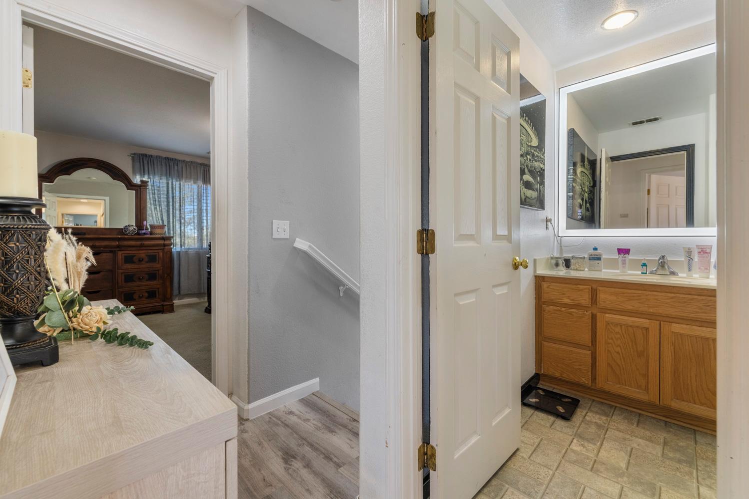 3145 Sweet Pea Avenue Merced, CA 95341 - Photo 19 of 25 a bathroom with a sink and a mirror