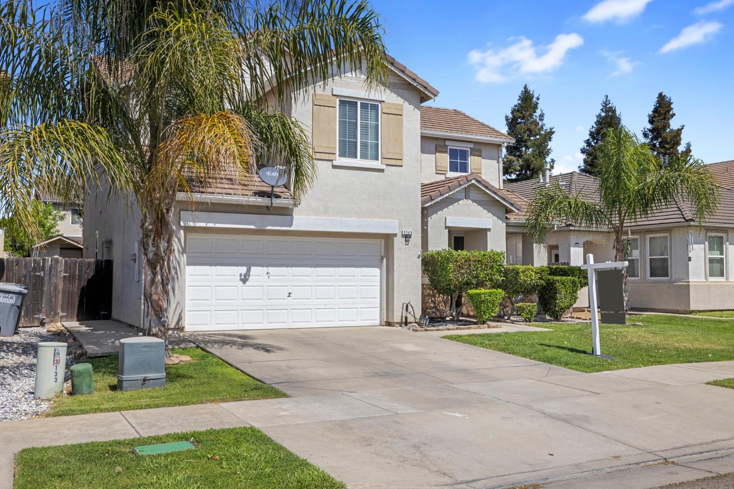 3145 Sweet Pea Avenue Merced, CA 95341 - Photo 2 of 25 a front view of a house with a yard
