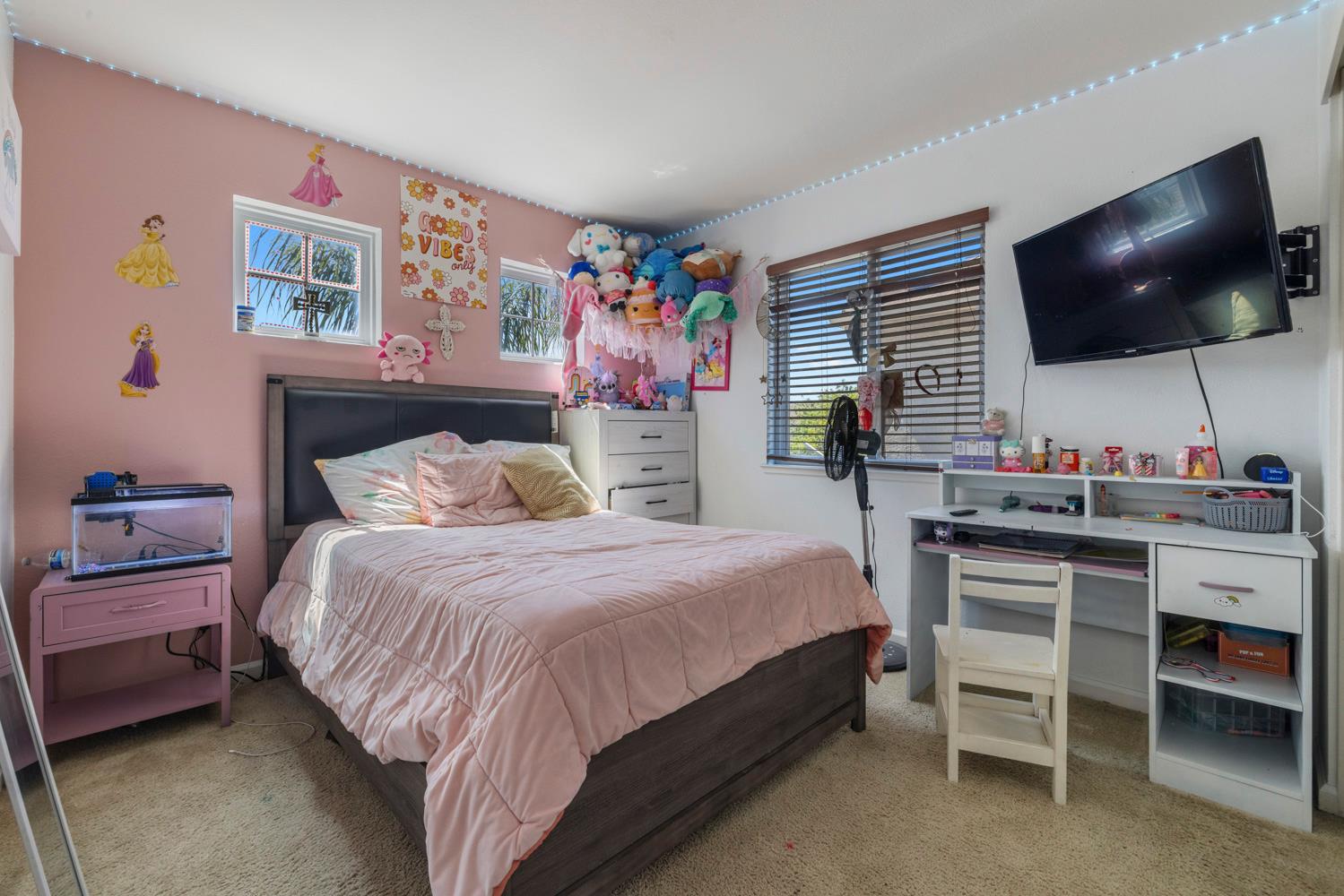 3145 Sweet Pea Avenue Merced, CA 95341 - Photo 21 of 25 a bedroom with a bed and a flat screen tv