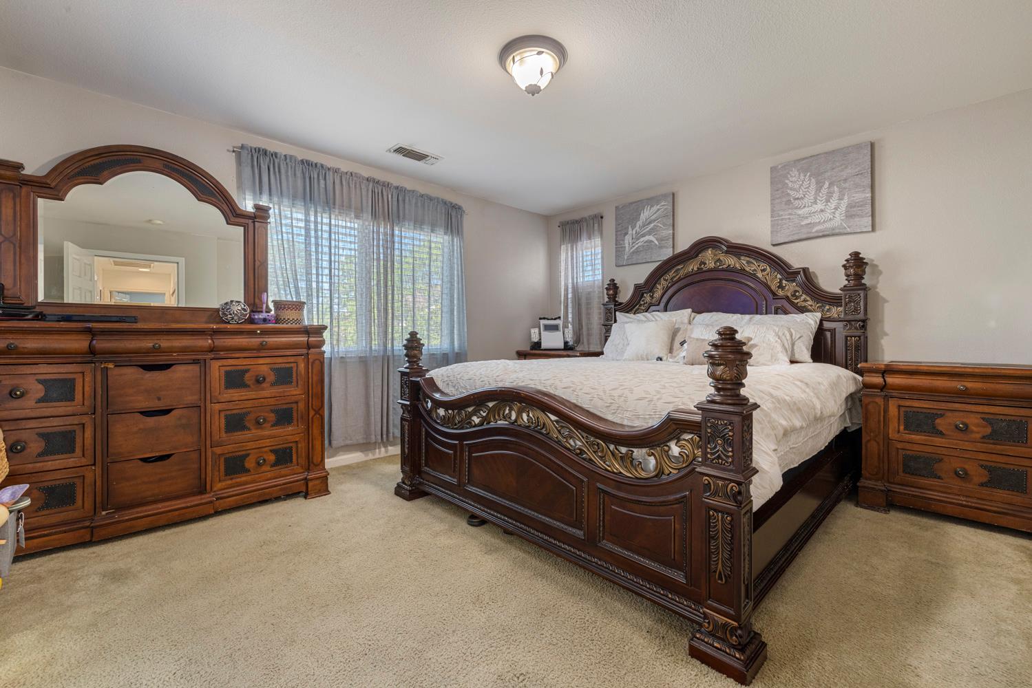 3145 Sweet Pea Avenue Merced, CA 95341 - Photo 24 of 25 a bedroom with a bed and a dresser