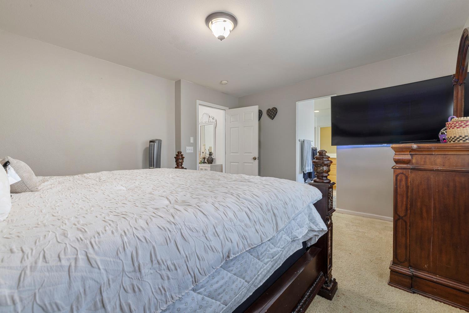 3145 Sweet Pea Avenue Merced, CA 95341 - Photo 25 of 25 a bedroom with a bed and a flat screen tv