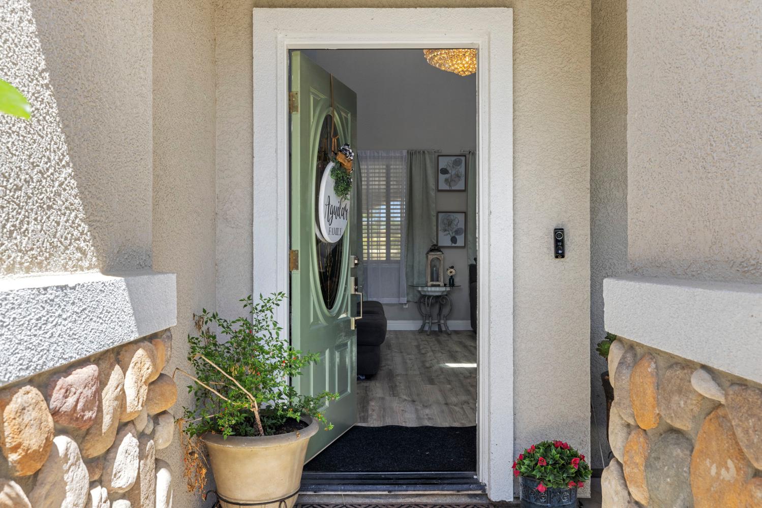 3145 Sweet Pea Avenue Merced, CA 95341 - Photo 3 of 25 a potted plant sitting in front of a door