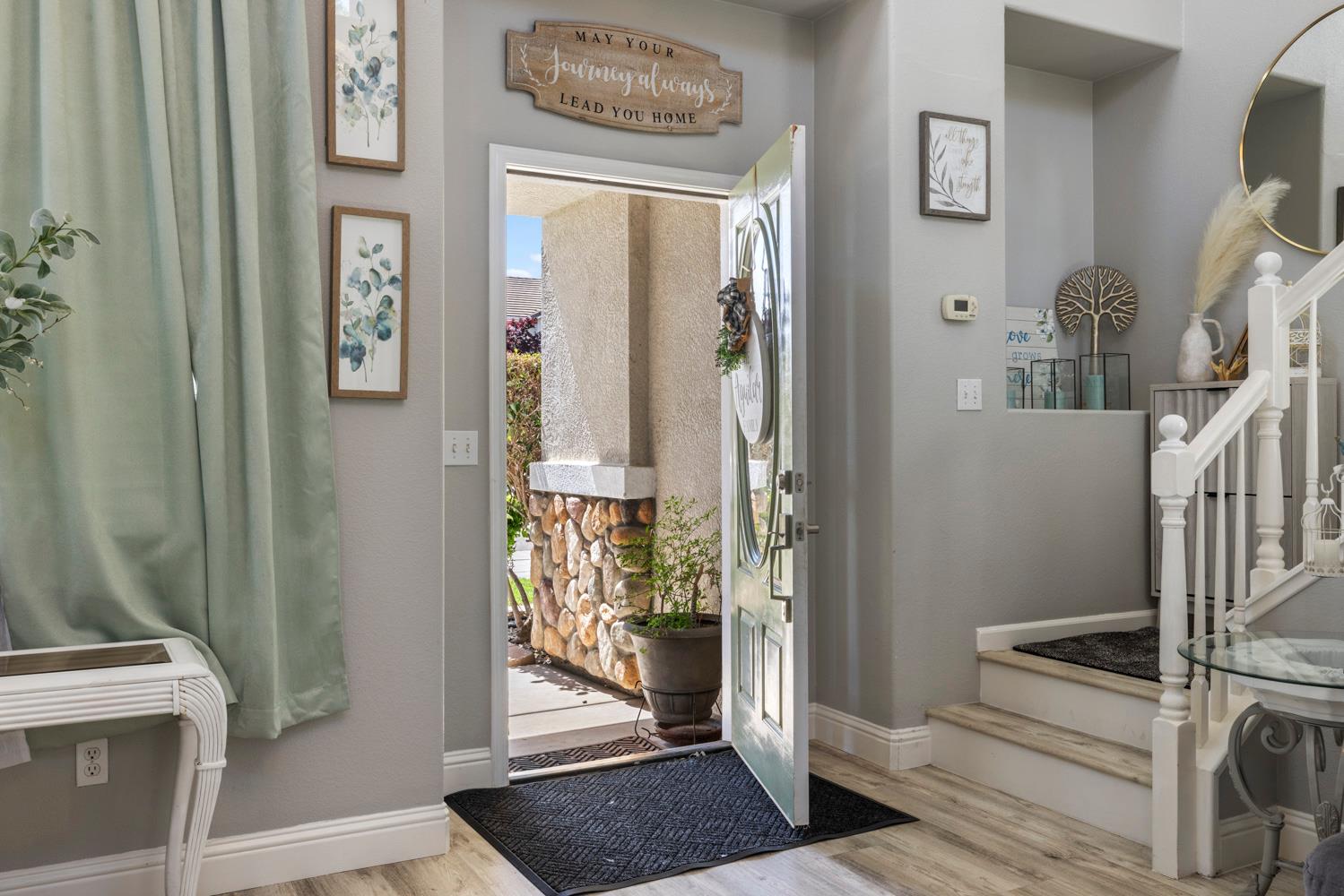 3145 Sweet Pea Avenue Merced, CA 95341 - Photo 4 of 25 a view of a hallway with wooden floor and entryway