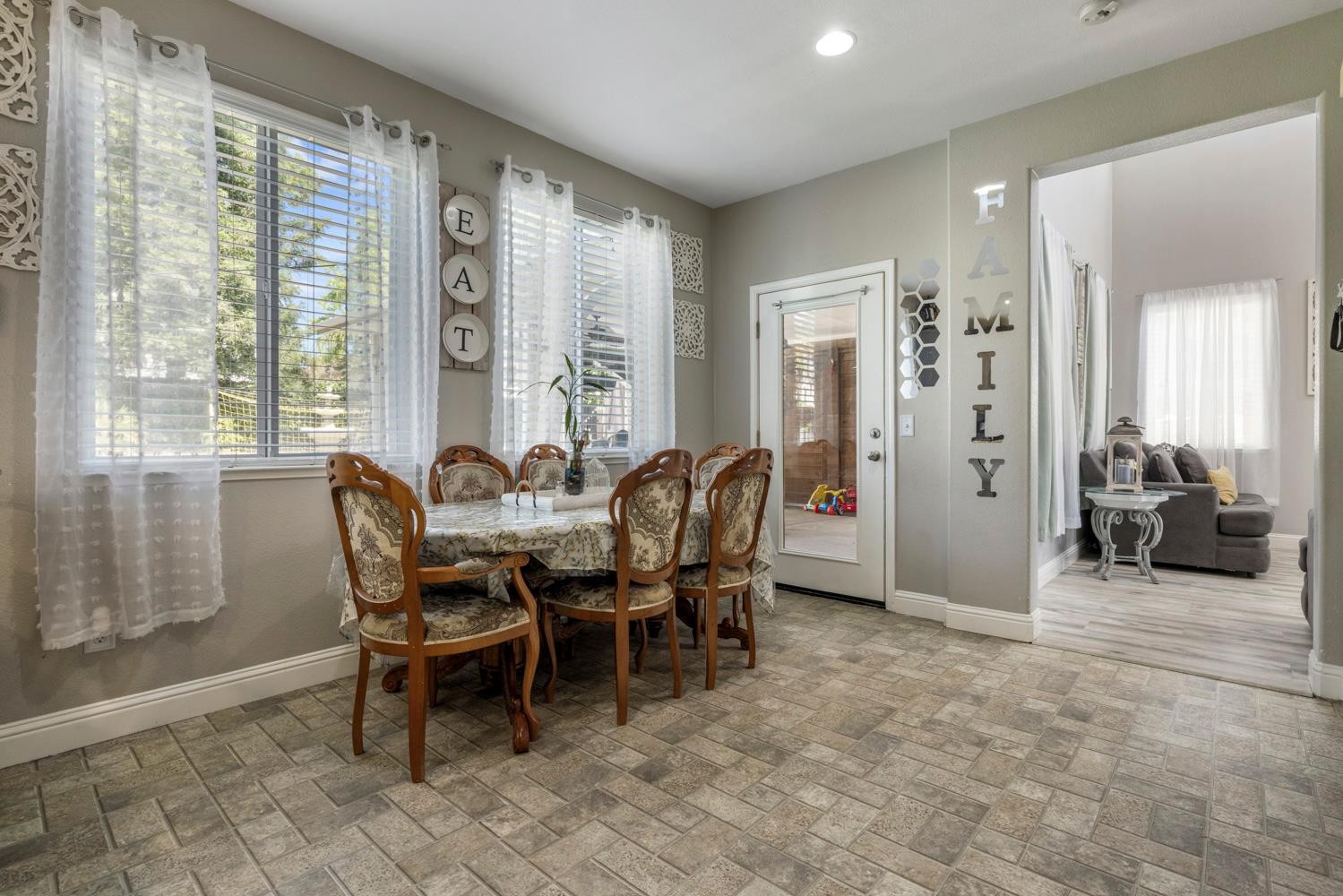 3145 Sweet Pea Avenue Merced, CA 95341 - Photo 9 of 25 a view of a dining room with furniture and a potted plant